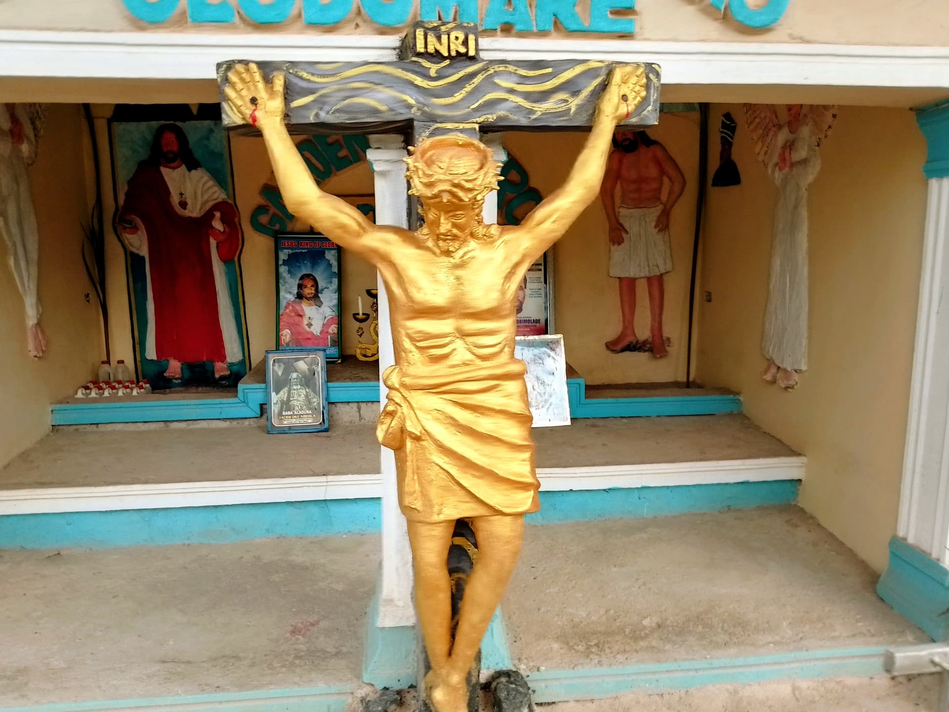 Golden crucifix at the Mimo Mimo Mimo Olodumare shrine